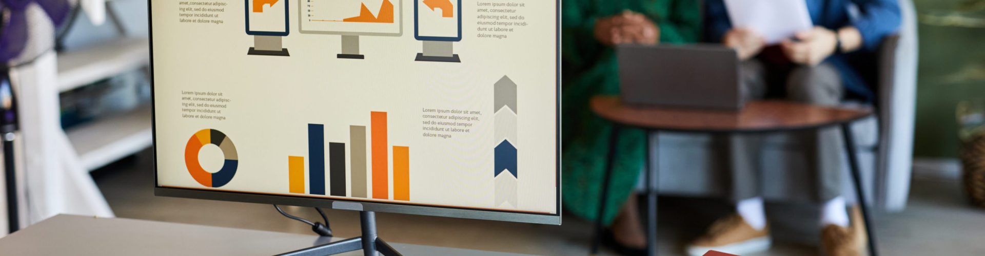 Computer screen with graphic data on workplace of economist or website designer with mouse, keypad, notebook and folder with papers