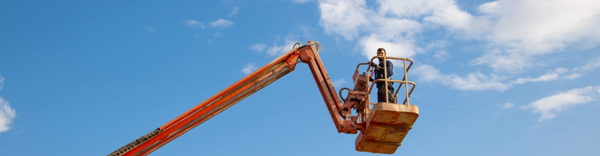 A low angle shot of a man working at a construction site - concept of construction