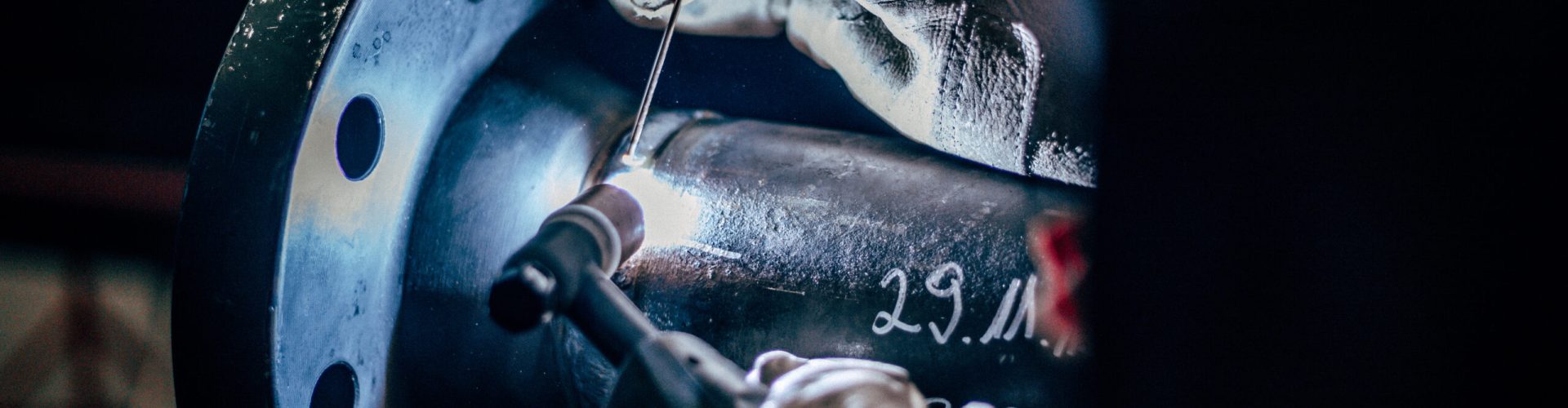 The worker welding metal in manufacturing plant